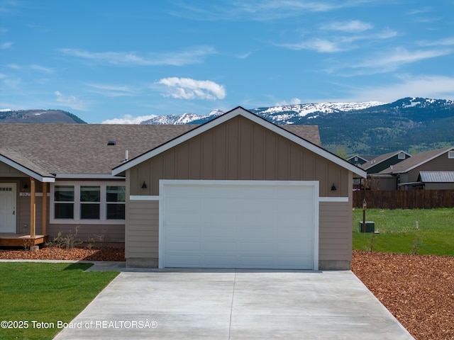 3829 Spruce Rd, Driggs, ID 83422 - single story home with a mountain view, a shingled roof, driveway, and an attached garage