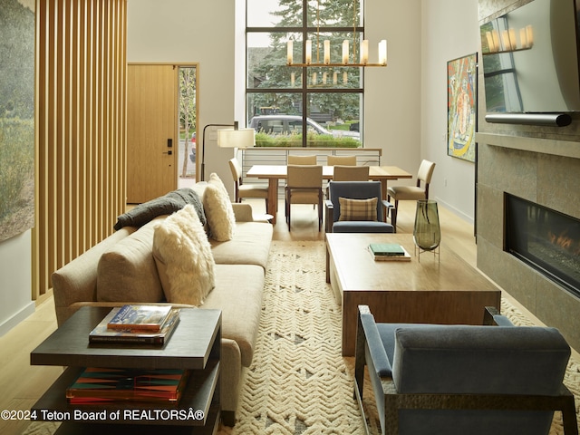 living room with light hardwood / wood-style flooring and a tiled fireplace