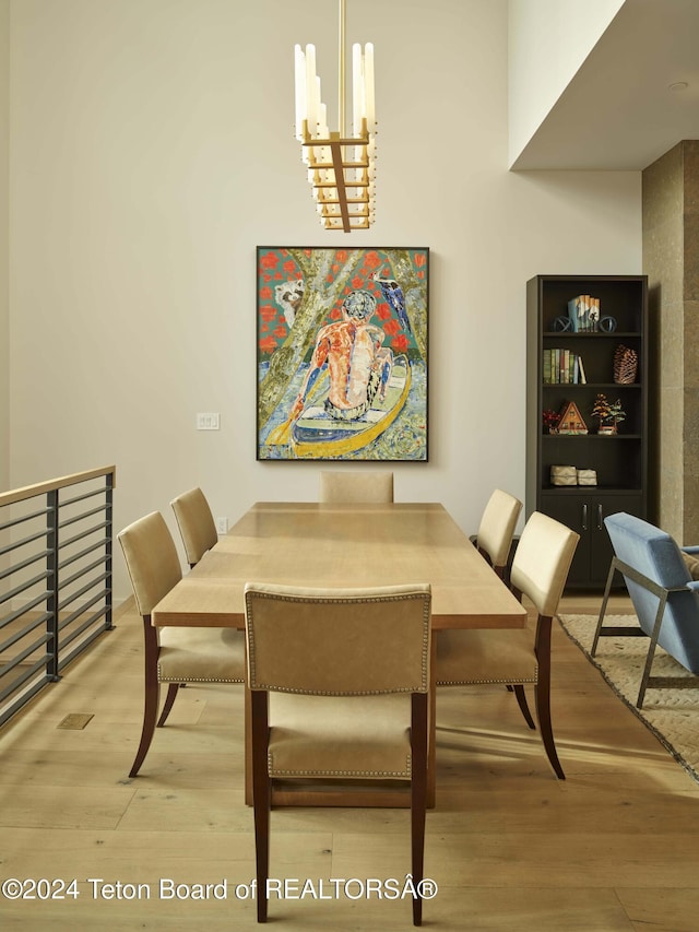 dining space with wood-type flooring and a chandelier