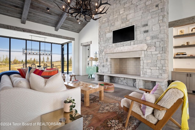 living room featuring hardwood / wood-style floors, wooden ceiling, high vaulted ceiling, a fireplace, and beamed ceiling