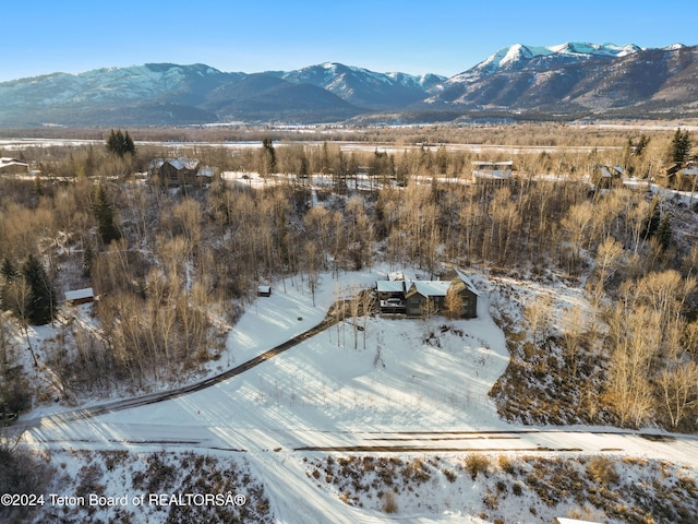 snowy aerial view with a mountain view