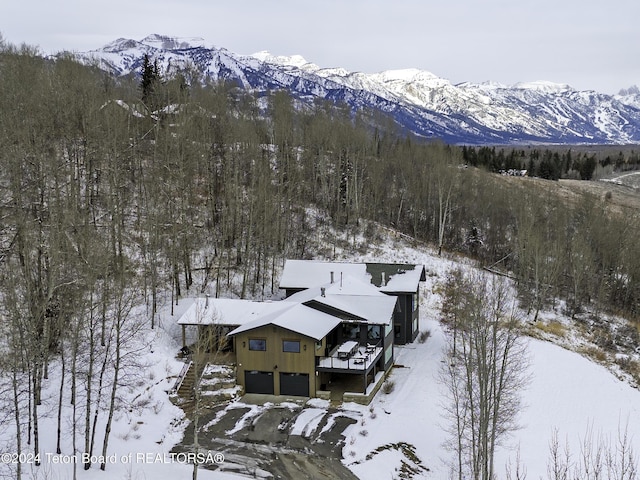 snowy aerial view with a mountain view