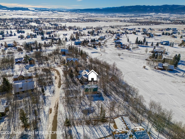 snowy aerial view with a mountain view