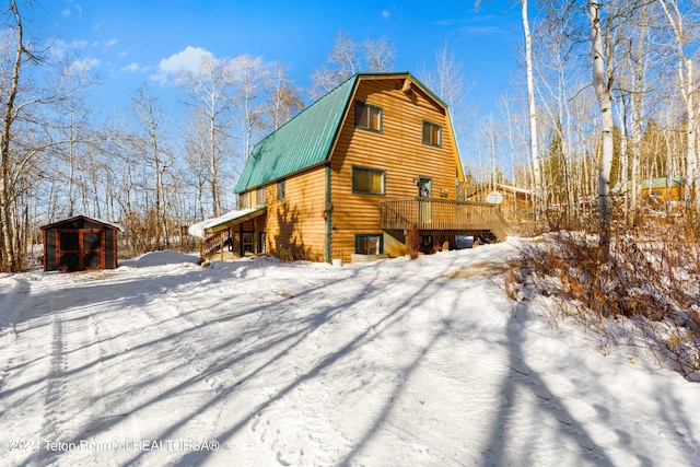 exterior space with a wooden deck and a shed