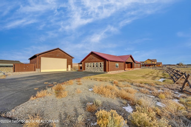 view of front of property with a garage and an outdoor structure