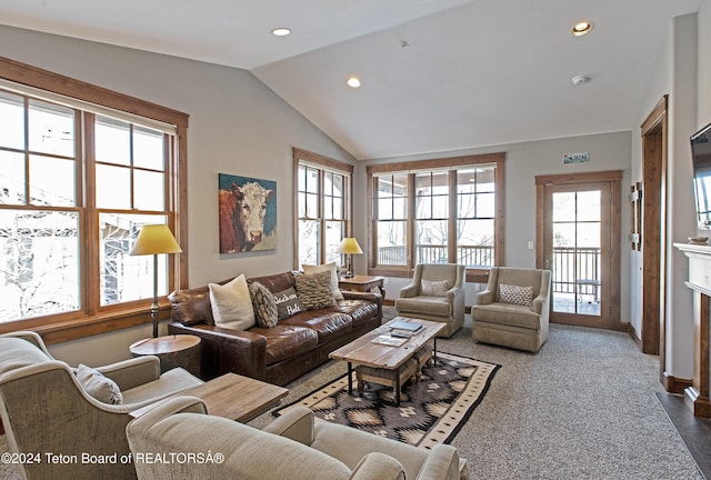 living room with vaulted ceiling and plenty of natural light