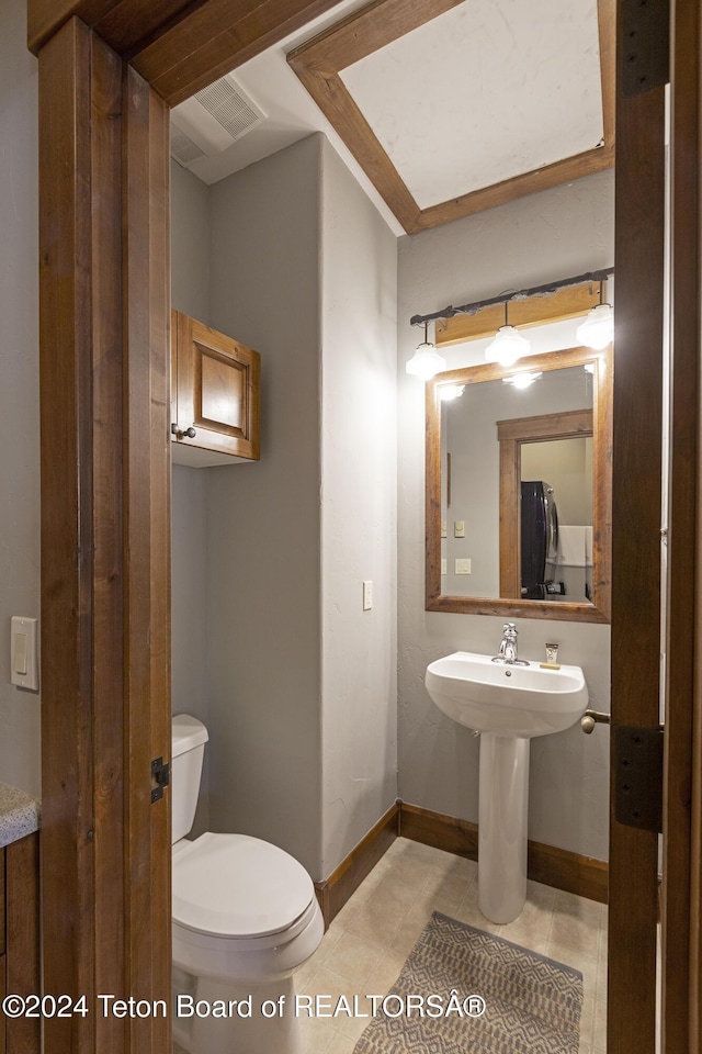 bathroom featuring tile patterned flooring and toilet