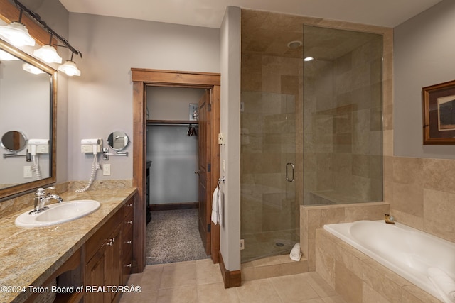 bathroom with tile patterned floors, vanity, and independent shower and bath