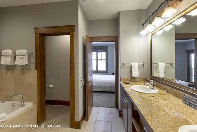 bathroom with tiled bath, tile patterned flooring, and vanity