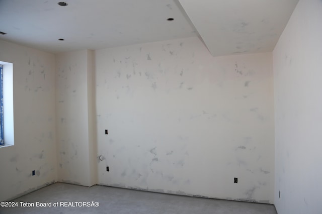 empty room featuring concrete floors and plenty of natural light