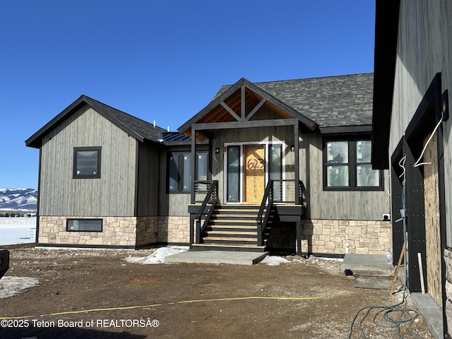 623 Royal Elk Cir, Victor, ID 83455 - view of front of home featuring a shingled roof, stone siding, and a mountain view