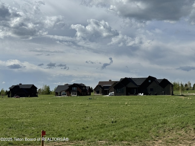 623 Royal Elk Cir, Victor, ID 83455 - view of green lawn with a rural view
