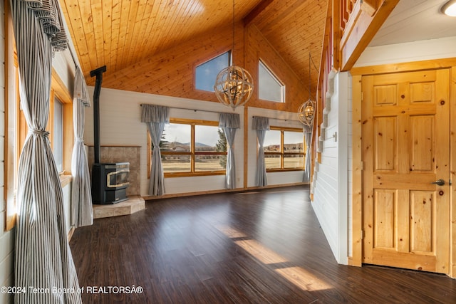 interior space featuring wooden ceiling, dark hardwood / wood-style flooring, a wood stove, and an inviting chandelier