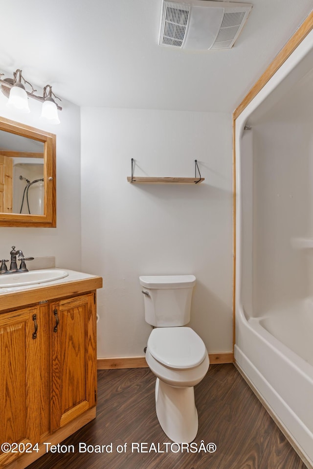 bathroom featuring vanity, toilet, and wood-type flooring