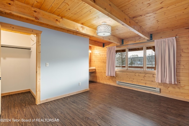 unfurnished bedroom featuring baseboard heating, dark wood-type flooring, beamed ceiling, a closet, and wood walls