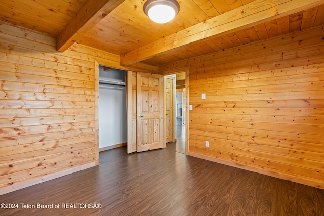 unfurnished bedroom with wood walls, beamed ceiling, wooden ceiling, and dark hardwood / wood-style floors