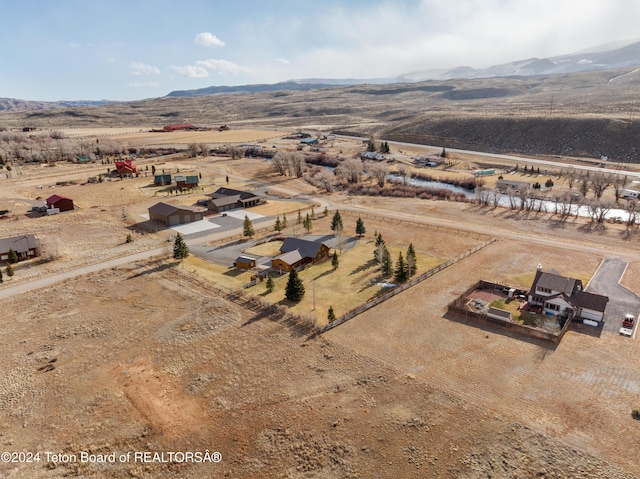 birds eye view of property featuring a mountain view and a rural view