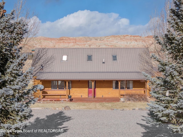 log-style house with a mountain view and covered porch