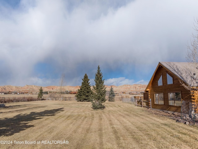 view of yard with a mountain view and a rural view