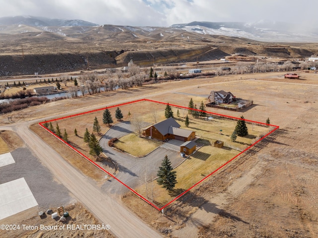 drone / aerial view with a mountain view and a rural view