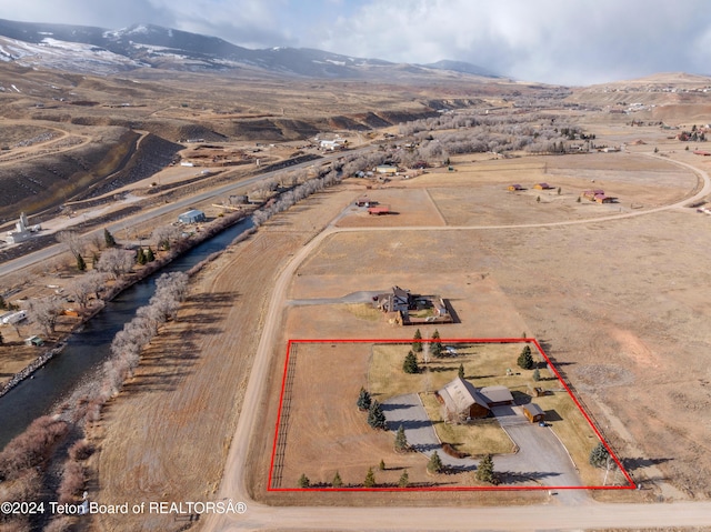 drone / aerial view featuring a mountain view and a rural view