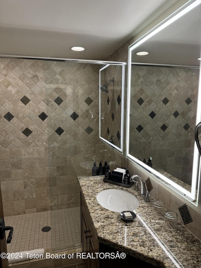 bathroom featuring vanity and a shower stall