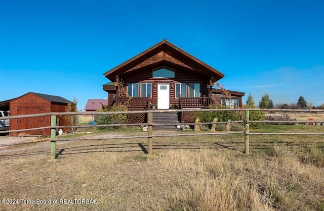 log home featuring a storage unit