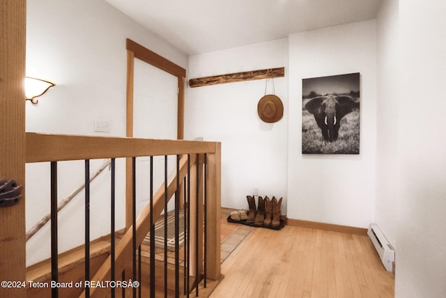 hallway featuring light hardwood / wood-style flooring and a baseboard radiator