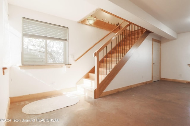 staircase with concrete flooring