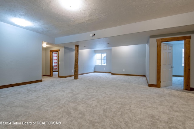 basement with light carpet and a textured ceiling