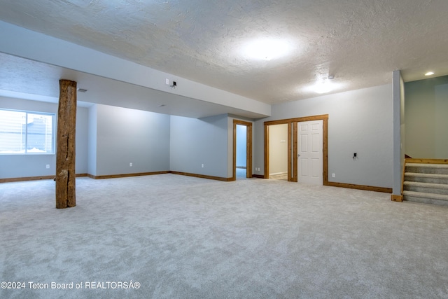 basement with carpet floors and a textured ceiling