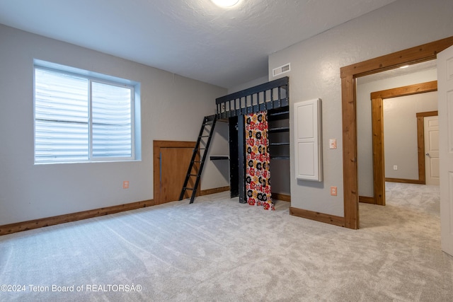 unfurnished bedroom with light carpet