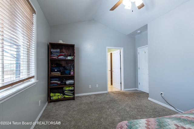 unfurnished bedroom featuring light carpet, vaulted ceiling, and ceiling fan