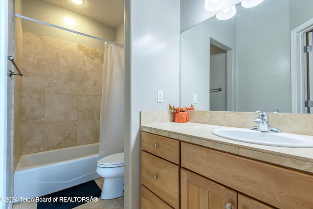 full bathroom with tile patterned flooring, shower / bath combo with shower curtain, vanity, and toilet