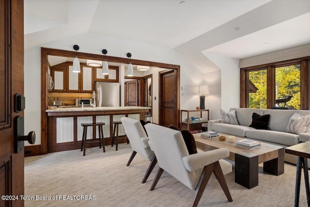 carpeted living room featuring lofted ceiling