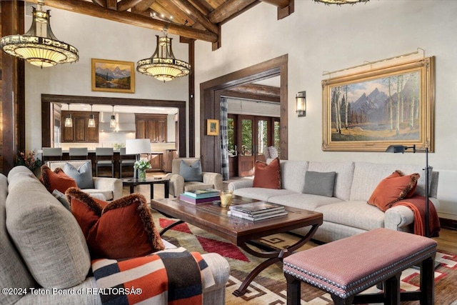 living room with beamed ceiling, hardwood / wood-style floors, and high vaulted ceiling