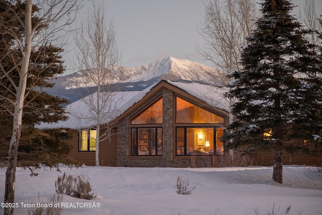 snow covered property with a mountain view