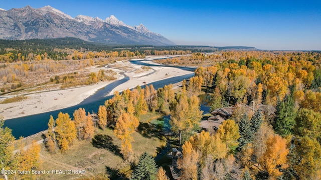 drone / aerial view featuring a water and mountain view