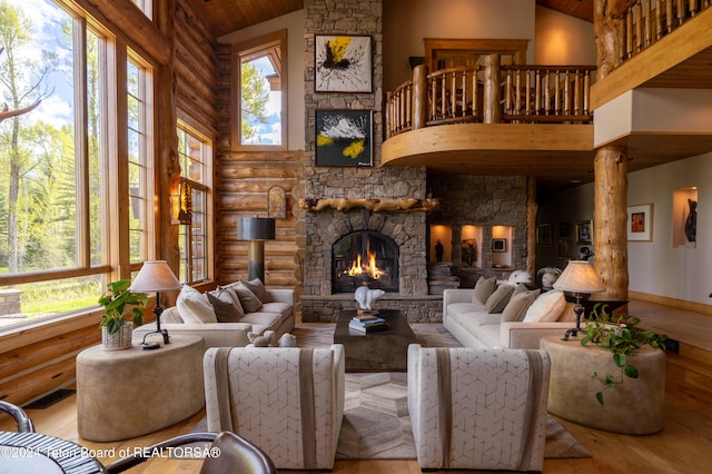 living room featuring rustic walls, a fireplace, high vaulted ceiling, and wood-type flooring