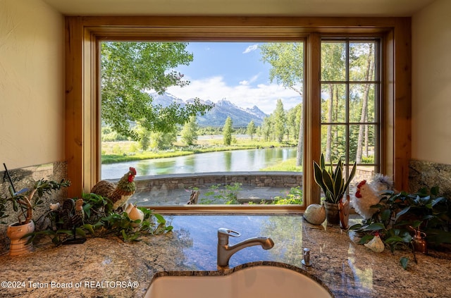 interior space featuring a water and mountain view and sink