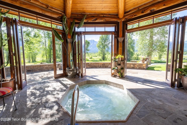 view of pool featuring a patio area and an in ground hot tub