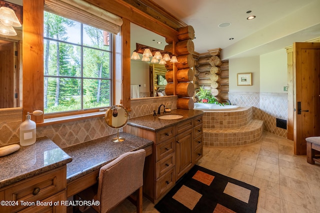 bathroom with log walls, decorative backsplash, vanity, and a relaxing tiled tub