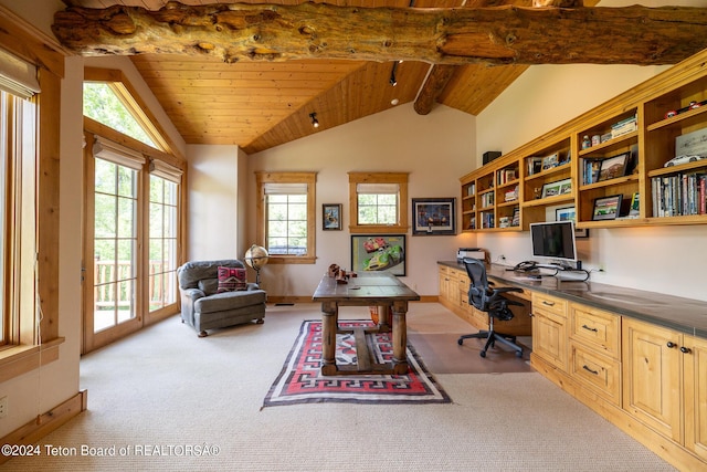 carpeted office space with vaulted ceiling with beams, built in desk, and wooden ceiling