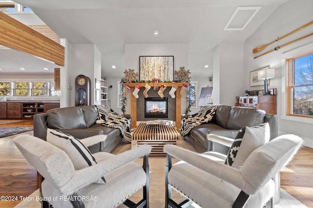 living room featuring light hardwood / wood-style floors and lofted ceiling