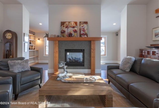 carpeted living room featuring a multi sided fireplace