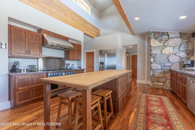 3470 W Mccollister Dr, Teton Village, WY 83025 - kitchen with high quality appliances, range hood, butcher block countertops, high vaulted ceiling, and dark wood-style floors