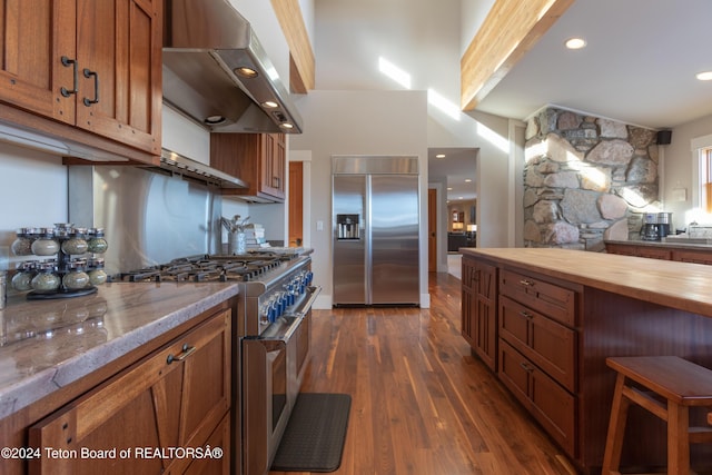 3470 W Mccollister Dr, Teton Village, WY 83025 - kitchen featuring premium appliances, island exhaust hood, brown cabinets, wooden counters, and recessed lighting