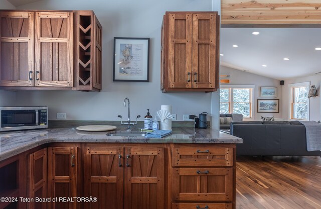 3470 W Mccollister Dr, Teton Village, WY 83025 - kitchen featuring stainless steel microwave, lofted ceiling, dark wood-style flooring, brown cabinetry, and recessed lighting