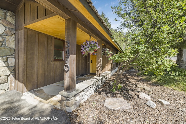 3470 W Mccollister Dr, Teton Village, WY 83025 - entrance to property featuring stone siding and a porch