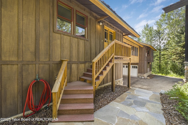3470 W Mccollister Dr, Teton Village, WY 83025 - view of exterior entry featuring board and batten siding and an attached garage